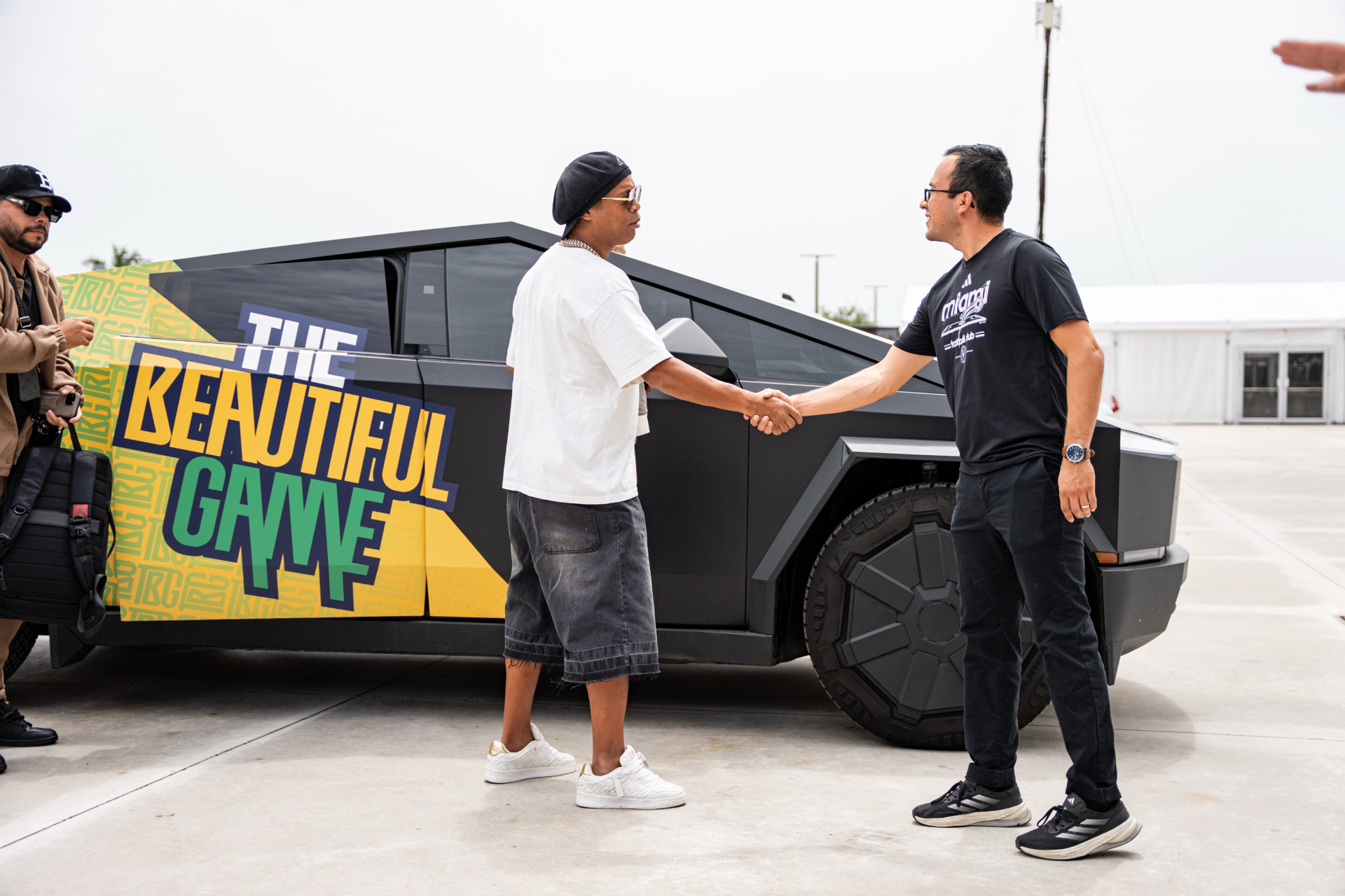 Juan Buitron shaking hands with Ronaldinho in front of The Beautiful Game Cybertruck.